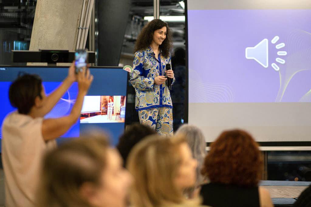 Almaza Faris presenting HUSH on stage